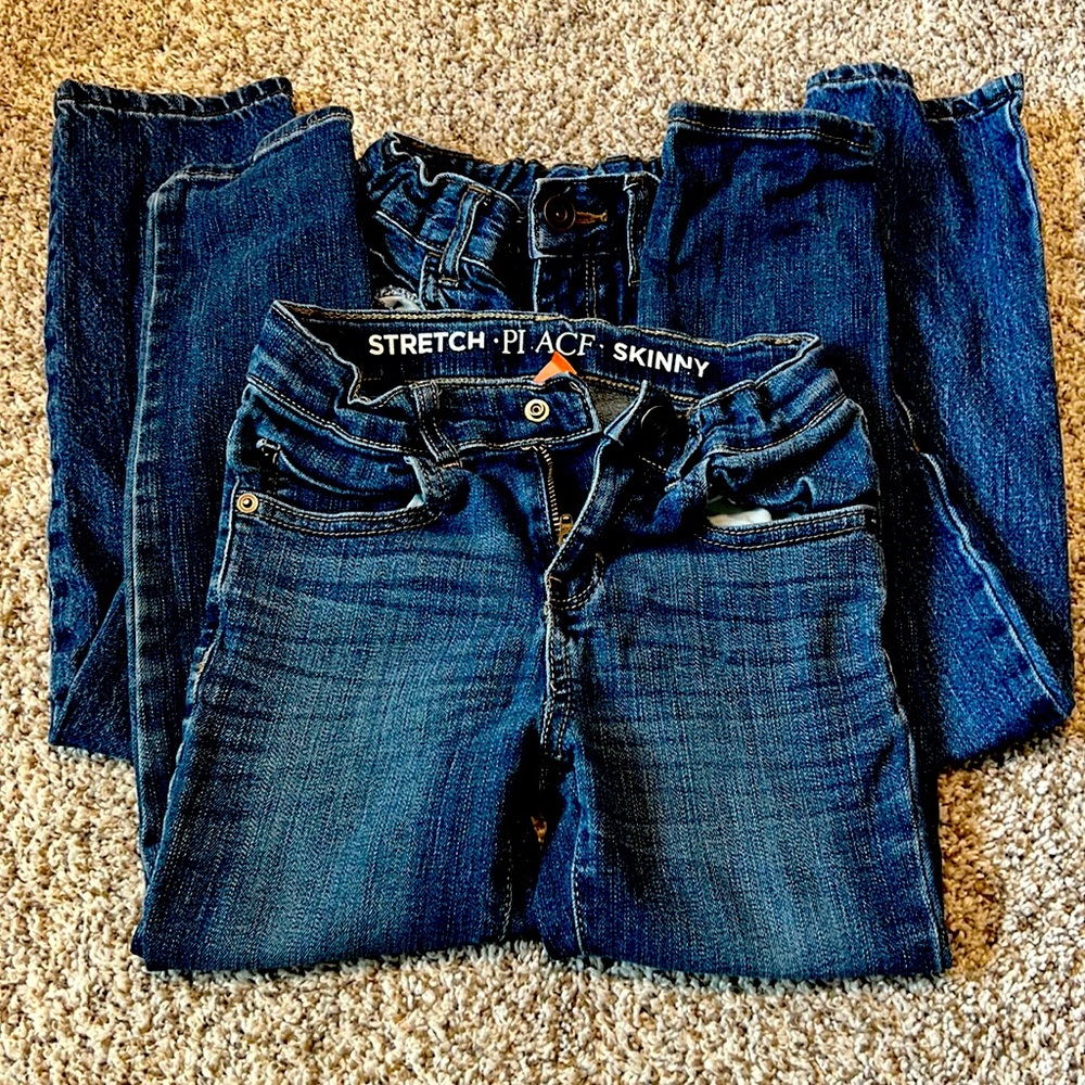 Two pairs of childrens place jeans.